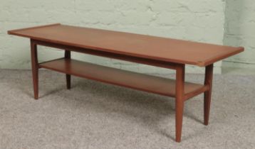 A mid century teak two tier coffee table. Height 36cm, Length 115cm.