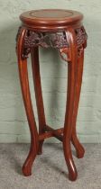 A hardwood carved jardiniÃ¨re stand. Hx82cm