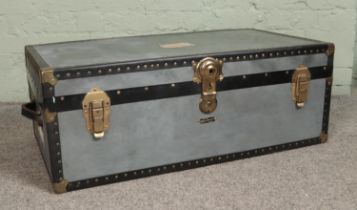 A Mossman Made metal travel trunk, with studded edges. Height: 33cm, Width: 90cm, Depth: 52cm.