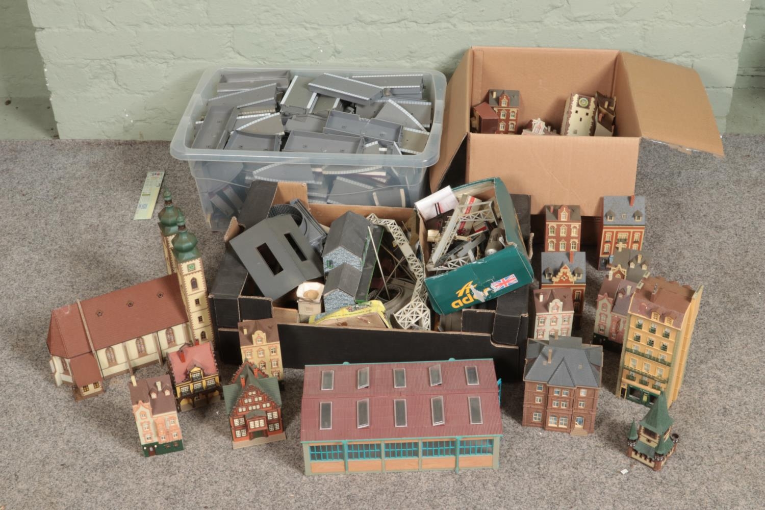Three large boxes of railway diorama accessories including a large quantity of buildings including