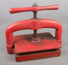 A cast iron Victorian book press with recumbent lion stamp to base with "QUALITY" underneath.