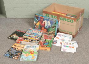 A box of assorted children's toys, games and annuals to include Blue Peter, Lego, Disney Books, etc.