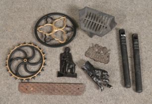 A collection of metalwares. Includes model of a hand, clock weights, treadle wheels etc.