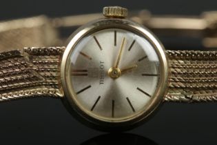 A ladies 9ct Gold Tissot manual wind wristwatch. With silvered dial and baton markers. Stamped to