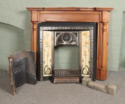 An art nouveau style cast iron tiled fireplace along with modern hardwood mantle.