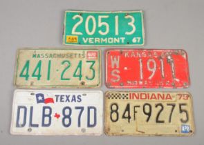 A collection of American tin licence plates. Includes Indiana, Vermont, Kansas, Texas and