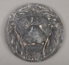 A circular cast iron lion mask plaque. Diameter 30cm.