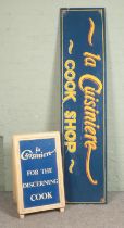 A large hand painted sign "La Cuisiniere Cook Shop" with matching A board sign. sign length 240cm