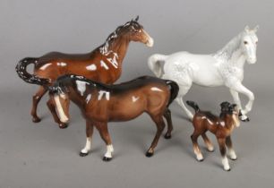 Four Beswick horses including trotting Dapple and foal examples. All have been previously repaired