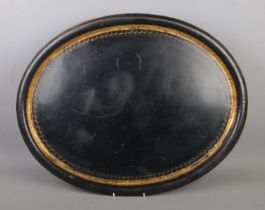 A large tole ware tray featuring gilt decorated border.