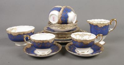 A Crown Staffordshire part tea service in the cobalt blue and gold pattern including platter,