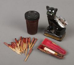 A Bakelite case of Bryant & May Ships Lifeboat Matches along with a novelty ceramic cat lighter