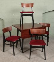 A mid century tola wood dining table along with a set of four chairs.