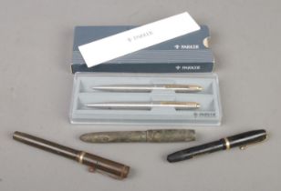 A Parker pen set along with three fountain pens with 14ct gold nibs. Includes Conway Stewart, The