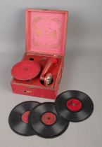The Diana Portable child's clockwork gramophone in red case along with three orchestra records.