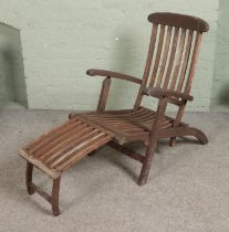 A teak and brass garden patio lounger.