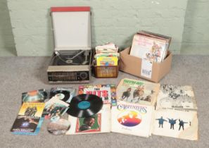 A Phillips Garrard portable turntable along with a collection of vinyl records and singles. Mainly