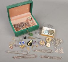 A vintage jewellery box with contents of jewellery. Includes enamelled fob watch, silver rings,
