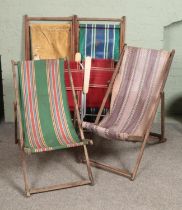 Four wooden deck chairs together with two folding garden chairs.