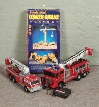 A Lucky Plastic remote control tower crane playset with two remote control fire trucks one by