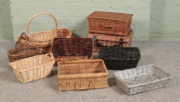 A quantity of wicker basket, to include two hamper baskets, shallow trays and hooped examples.