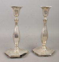 A pair of silver candlesticks, of hexagonal form with filled bases. Partial hallmarks for