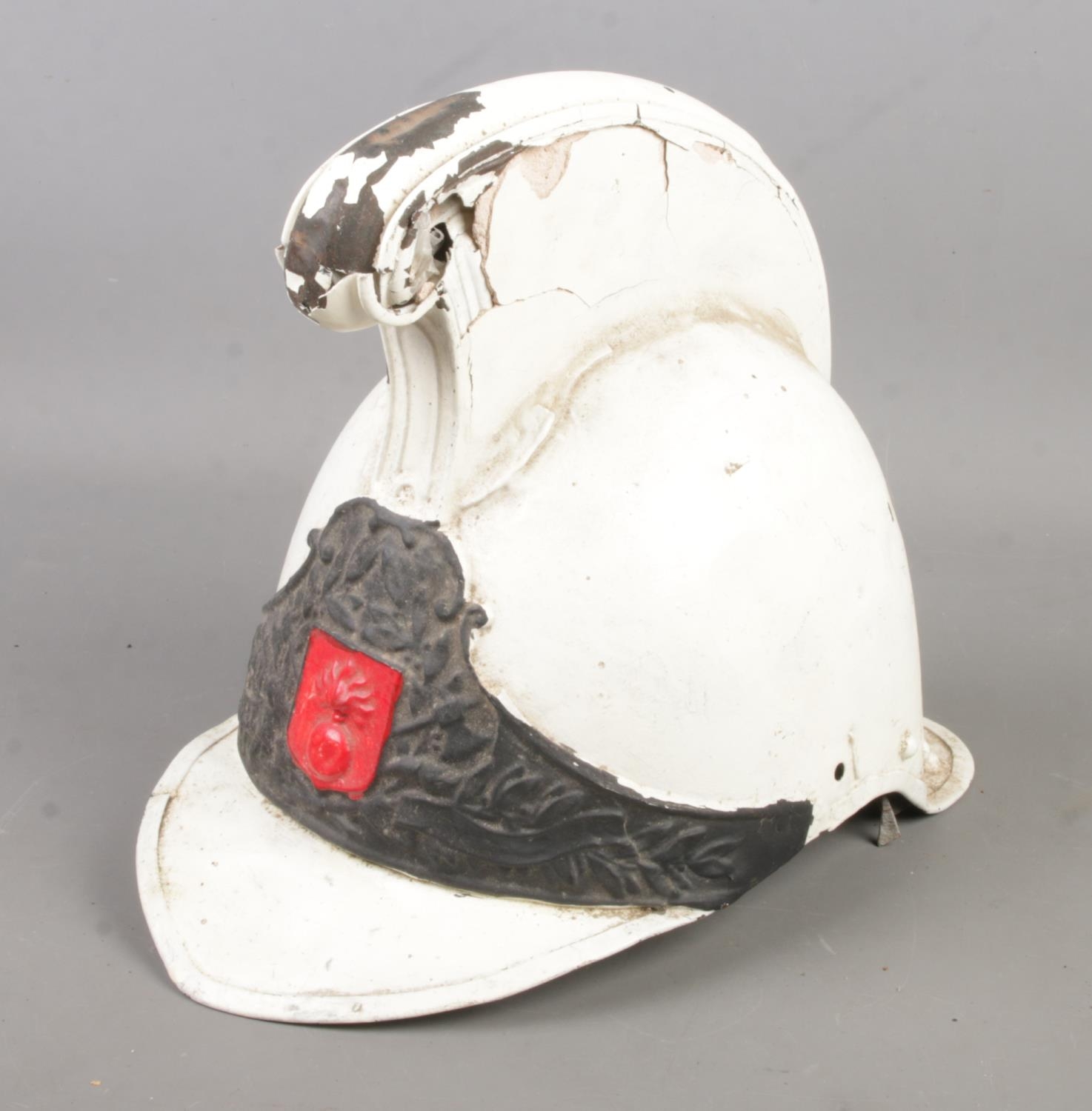 A painted Merryweather style helmet with flaming grenade motif to the front.