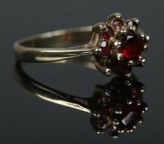 A gold cluster ring, set with garnets. Tests as 9ct. Size KÂ½. Total weight: 1.7g
