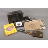 An assorted mix of collectables including cigarette cards, an album of stamps from around the world,