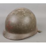 A military steel helmet, possibly American M1.