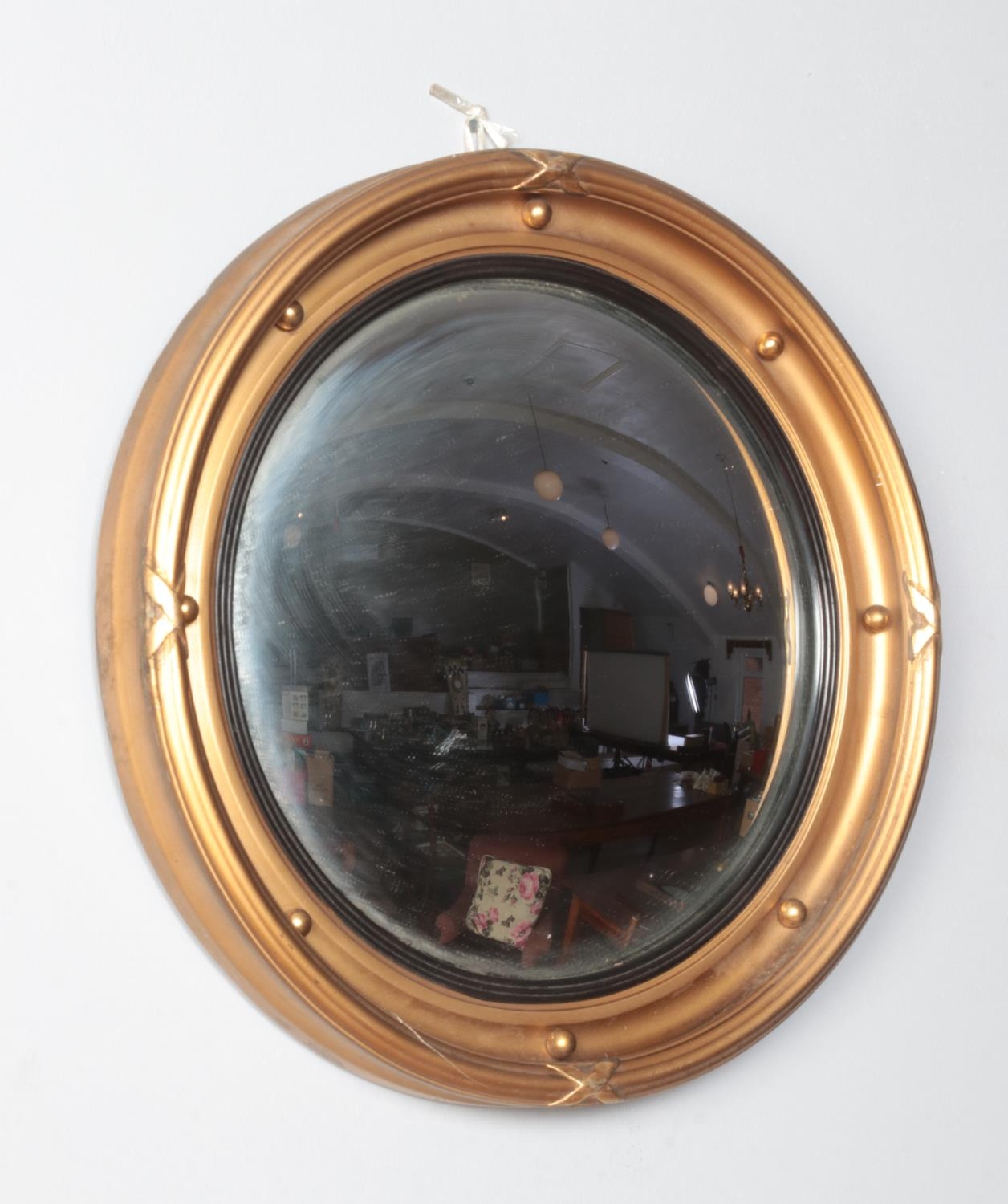A gilt framed circular convex mirror. 32cm diameter.