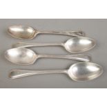 A set of four early Twentieth Century silver table spoons, bearing 'G' to the top of the handle.