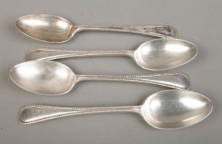 A set of four early Twentieth Century silver table spoons, bearing 'G' to the top of the handle.