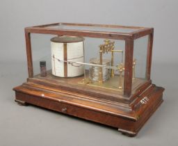 A John Davis & Son oak and glass cased barograph/weather machine.