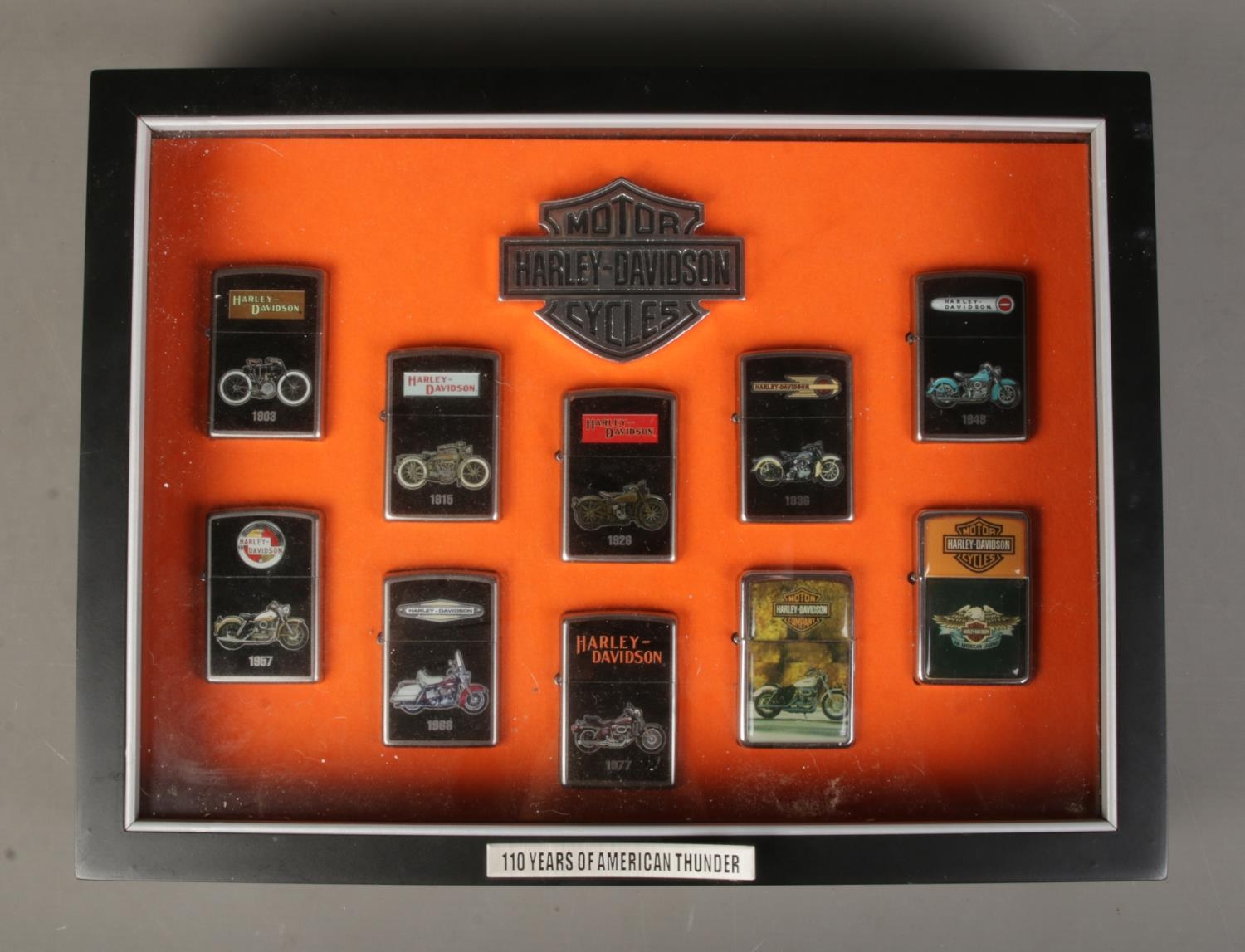 A Harley Davidson cased set of Zippo "100 Years Of American Thunder" lighters, containing 8/10 - Image 2 of 2