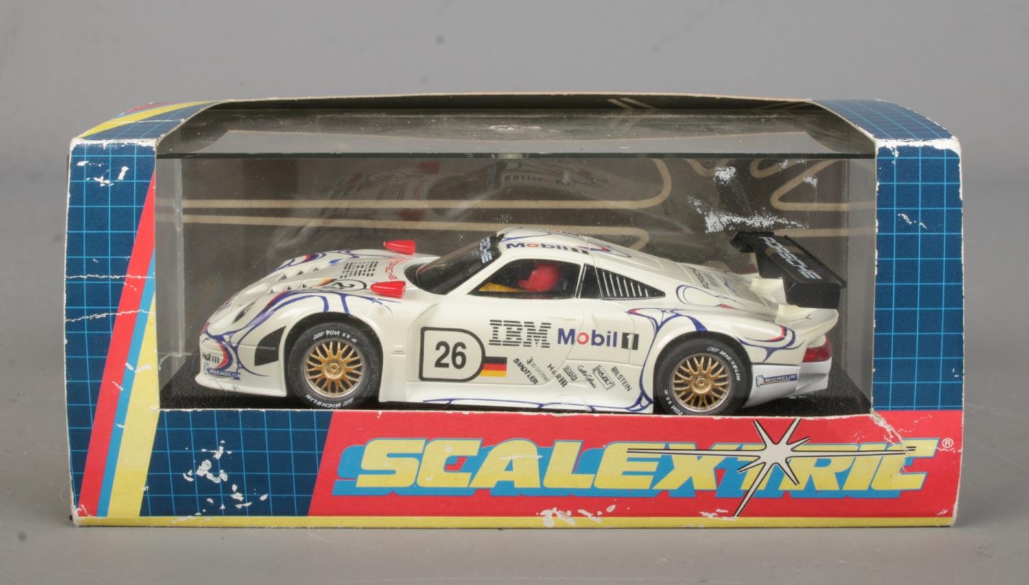 A boxed Hornby Scalextric Porsche 911 race car.