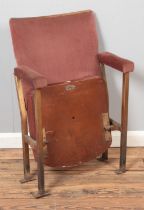 A single vintage cinema seat with plaque to base and Number 8 plaque.