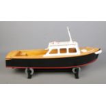 A motorised kit model pond cruiser boat on display stand. Approx. boat length 63cm. No remote
