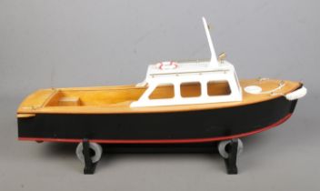A motorised kit model pond cruiser boat on display stand. Approx. boat length 63cm. No remote