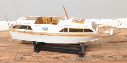 A motorised kit model of a Fairey Huntsman powerboat on display stand. Approx. boat length 85cm.