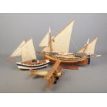 Three kit built model displays to include fishing boat on display stand and propellor plane.