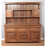 A large oak Welsh dresser with drawer and cupboard base.