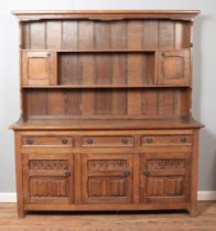 A large oak Welsh dresser with drawer and cupboard base.