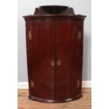 A mahogany bow fronted corner cupboard with upper tier. Height 102cm, Width: 68cm.