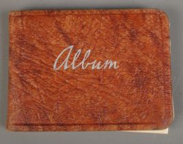 A vintage autograph album containing a collection of signatures, including examples for singers
