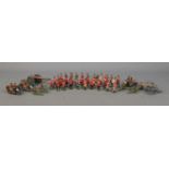 A collection of lead soldier figures, including Britains examples. Features marching band, cannons