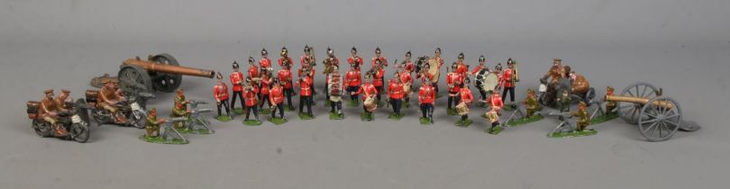 A collection of lead soldier figures, including Britains examples. Features marching band, cannons