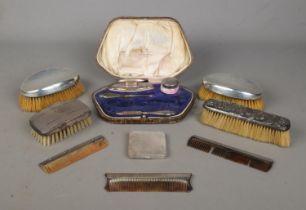 A collection of dressing table silver and silver mounted items. To include powder compact,