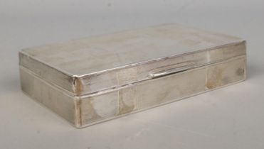 A George V silver mounted hinged cigarette box. With engine turned front and blank rectangular