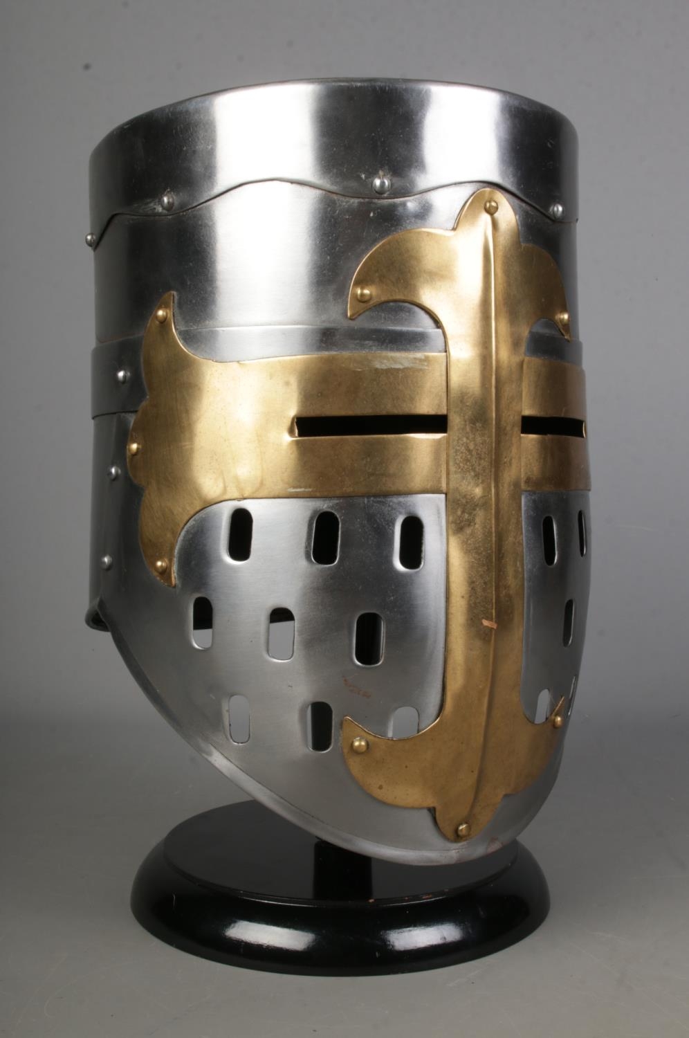 A replica medieval helmet on black display stand, life size model.